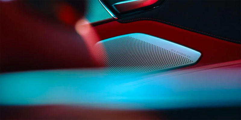 Close-up of a 2025 Acura RDX speaker with ELS Studio name, illuminated with colorful light.