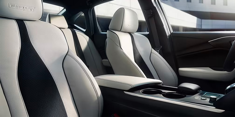 Stylish 2025 Acura TLX interior featuring modern front seats with light gray upholstery and a center console.