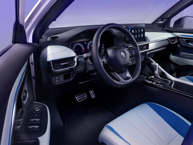 Modern 2025 Acura ADX interior with a black and blue steering wheel, high-tech dashboard, and stylish seats.