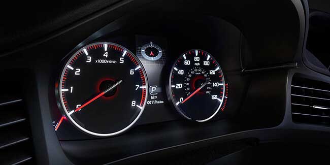 Acura dashboard showing speedometer and tachometer with digital display.