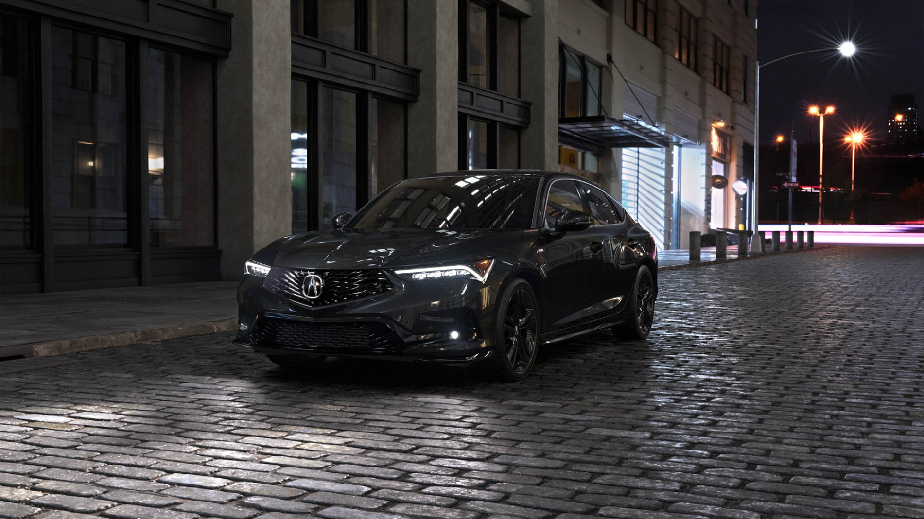 2026 Acura Integra CVT parked on a city street at night.